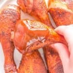 smoked chicken leg with BBQ sauce on it chicken legs in back ground