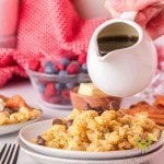 Pouring maple syrup on scrambled pancakes (Kaiserschmarrn) with chocolate chips added.