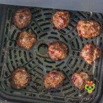 Our homemade blend of spices and flavors balances the savory and sweetness of these meatballs. Nine air fried cranberry meatballs resting in the air fryer basket.