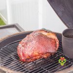 The Big Green Egg smoking a pork butt with our BBQ rub that has a dark red mahogany color with a deep crack in the fat cap. Once finished smoking you get Big Green Egg pulled pork with our BBQ rub. It is such a tasty option for making a pulled pork burger.