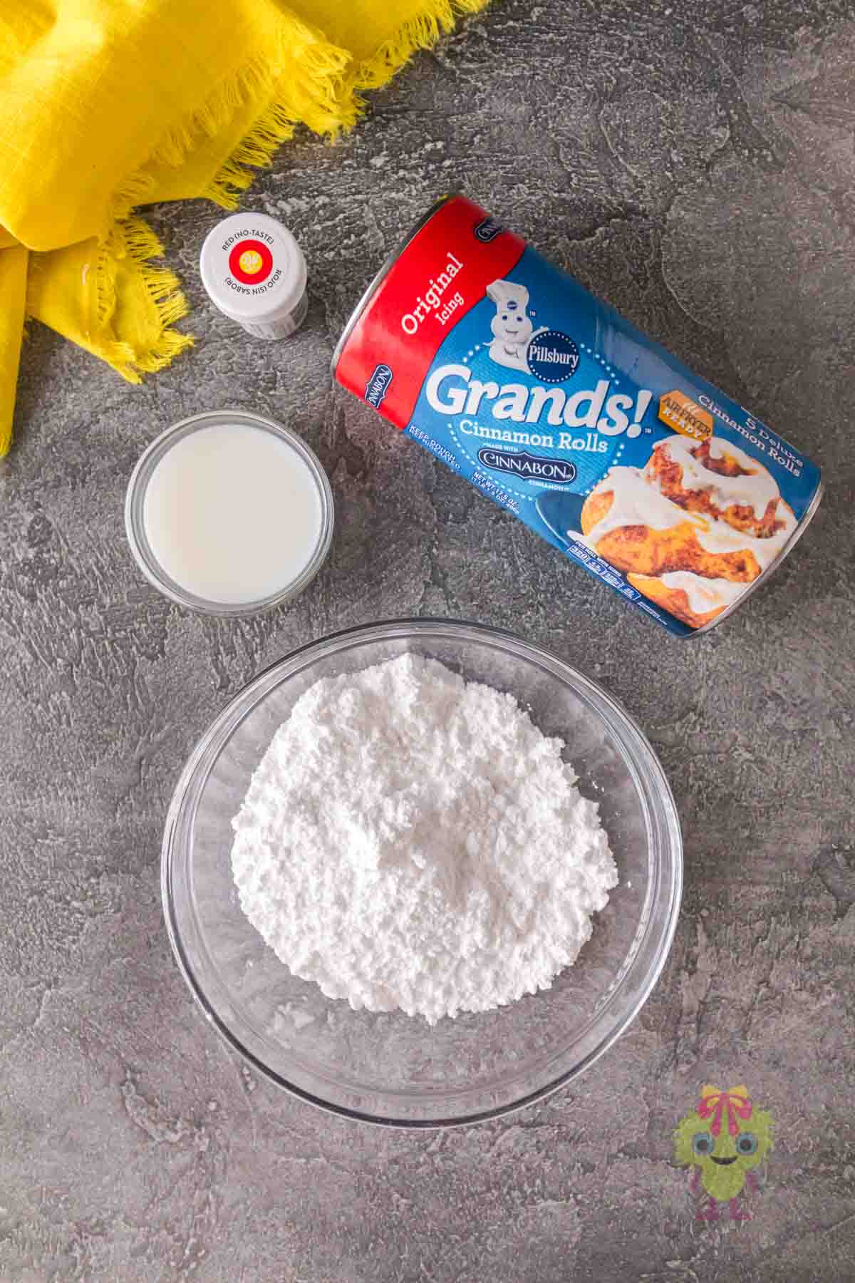 Overhead shot of the Halloween cinnamon rolls ingredients, only four.