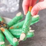 Get ready to cast a spell on snack time with these Halloween pretzels! The picture show a witch finger pretzel above a plate of witch finger pretzels. So grab your broomsticks and let’s get munching!