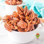 Homemade honey roasted pecans ready to be enjoyed in a serving bowl.