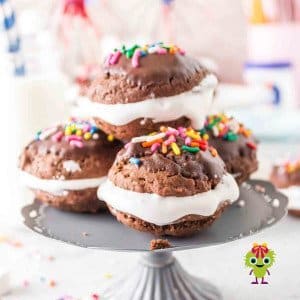 Chocolate marshmallow sandwich cookies that are topped with melted chocolate and funfetti. Ready to be enjoyed.