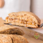 A pecan pie scone is being served from the rest, fresh and warm, straight from the oven.