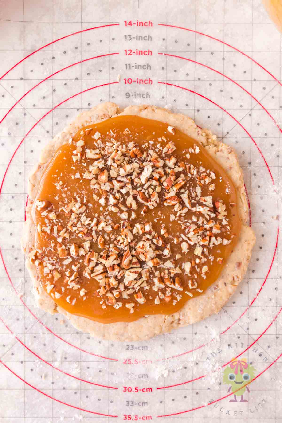 Showing how to make the scones into a pecan pie scone by adding the sweet and nutty caramel filling.