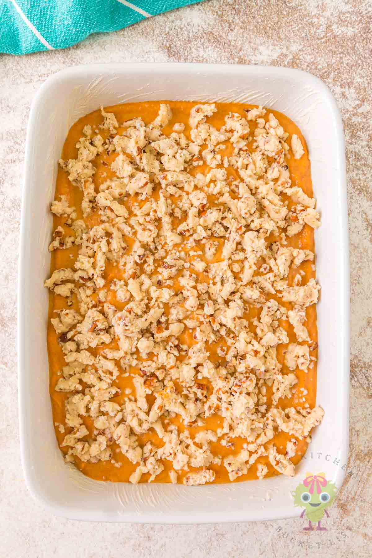 A butter 9x13 baking dish showing how easy it is to layer in the cake and pumpkin mixtures.