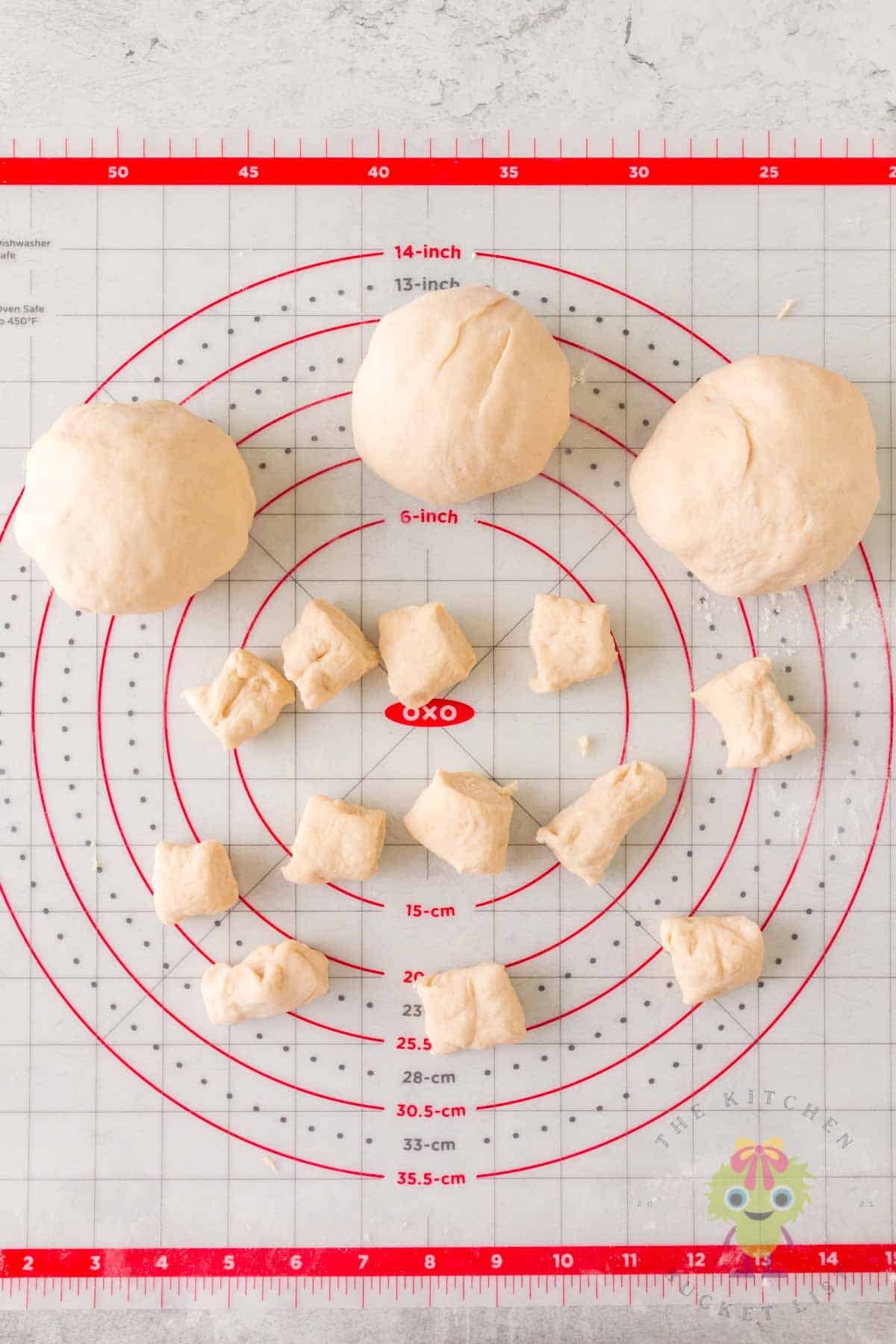 Dough balls and sliced pretzel bite pieces on the work surface, showing how the dough is shaped and cut before baking.