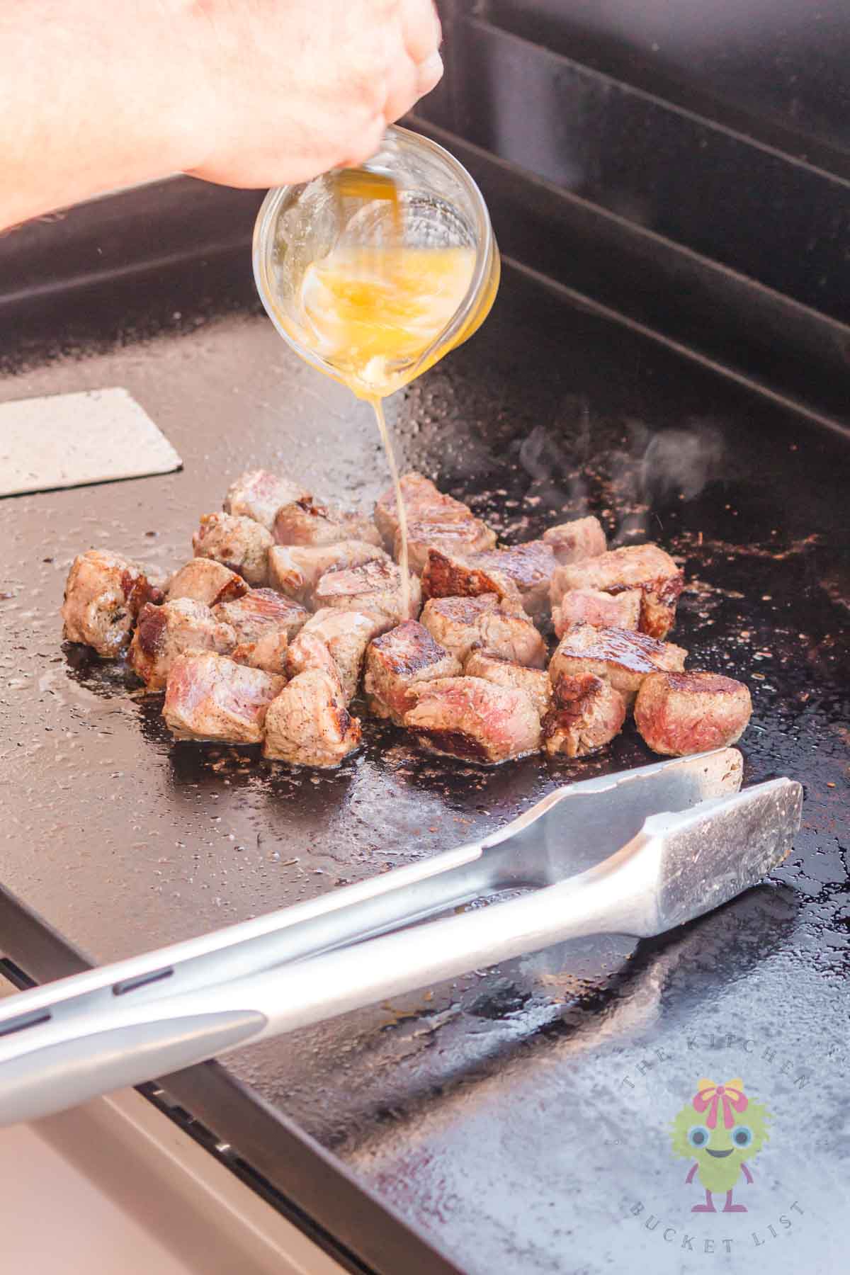 The final step is to pour the garlic butter over the steak bites and mix. This garlic butter bath is what makes them irresistible.