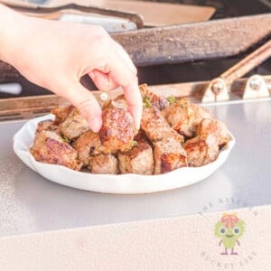 A picture of me stealing a garlic steak bite from the serving bowl. Using the NY strip steak, pantry staples for the dry rub, and finishing with the garlic butter bath really makes these steak bites my go-to for a quick steak night.